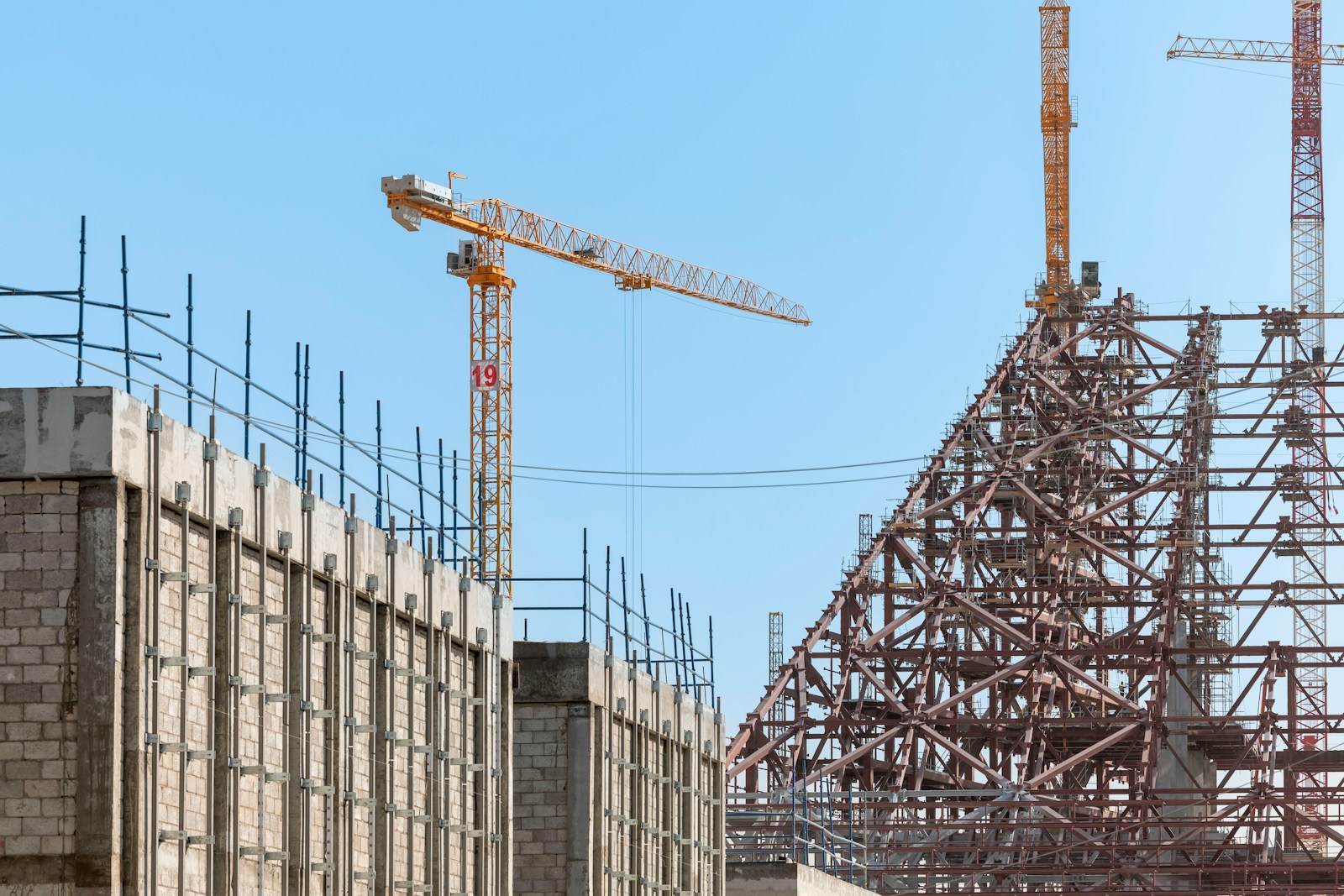 A building under construction with a crane in the background